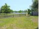 Lush backyard features a partial wooden fence with serene water views at 3254 Hartwell St, Johns Island, SC 29455