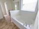 Spacious bathtub with chrome faucet in a bright bathroom with tile floors at 3254 Hartwell St, Johns Island, SC 29455