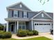 Charming two-story home with gray siding, a two-car garage, and well-maintained landscaping at 3254 Hartwell St, Johns Island, SC 29455