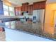 Modern kitchen with granite countertops, stainless steel appliances, and dark wood cabinets at 3254 Hartwell St, Johns Island, SC 29455