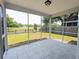 Relaxing screened porch with tile flooring, overlooking a beautiful backyard and lake at 3254 Hartwell St, Johns Island, SC 29455