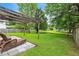 Lush backyard with a pergola and a serene water feature, perfect for outdoor relaxation and entertaining at 3290 Middleburry Ln, Charleston, SC 29414