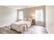 Cozy bedroom with wood-look floors, a comfortable bed, and natural light streaming through two windows at 3290 Middleburry Ln, Charleston, SC 29414