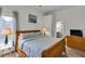 Bedroom featuring two windows, wood look floors, king bed, dresser, and open bathroom at 3290 Middleburry Ln, Charleston, SC 29414