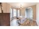 Light filled dining room with wood floors, chandelier, table and chairs and entry to hallway at 3290 Middleburry Ln, Charleston, SC 29414