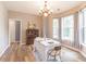 Dining room featuring chandelier, bright windows, table and chairs and wood-look floors at 3290 Middleburry Ln, Charleston, SC 29414
