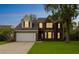 Exterior view of a brick home at twilight, showcasing illuminated windows and landscaped yard at 3290 Middleburry Ln, Charleston, SC 29414