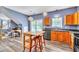 Bright eat-in kitchen with stainless appliances, gray counters, wood cabinets, island and door to back yard at 3290 Middleburry Ln, Charleston, SC 29414