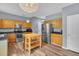 Eat-in kitchen featuring stainless steel appliances, wood cabinets, modern lighting and light wood flooring at 3290 Middleburry Ln, Charleston, SC 29414
