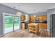 Bright kitchen features wood cabinets, stainless steel appliances, and adjacent access to the backyard at 3290 Middleburry Ln, Charleston, SC 29414