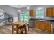 Well-lit kitchen featuring wood cabinets, stainless steel appliances, light wood flooring, and backyard views at 3290 Middleburry Ln, Charleston, SC 29414