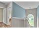 Second floor landing with half-moon window providing view of yard and pond at 3290 Middleburry Ln, Charleston, SC 29414