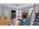Comfortable living room featuring a brick fireplace, hardwood floors, and ample natural light at 3290 Middleburry Ln, Charleston, SC 29414