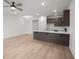 Open-concept living area with light wood floors and view into an adjacent kitchen at 335 Bremerton Dr, Goose Creek, SC 29445