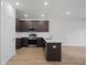 A modern kitchen featuring stainless steel appliances, dark brown cabinets, and a center island at 335 Bremerton Dr, Goose Creek, SC 29445