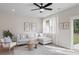 Bright living room boasts a comfy sectional, area rug, and access to the backyard at 335 Bremerton Dr, Goose Creek, SC 29445