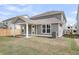 Rear exterior view with covered patio and expansive backyard, perfect for outdoor gatherings at 327 Hillman Trl Dr, Moncks Corner, SC 29461