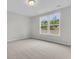 Comfortable bedroom featuring neutral carpet and windows letting in natural light with views of the backyard at 327 Hillman Trl Dr, Moncks Corner, SC 29461