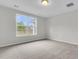 A sun-filled bedroom featuring neutral walls, carpet, and large windows overlooking trees in the backyard at 327 Hillman Trl Dr, Moncks Corner, SC 29461