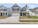 Charming two-story home with gray siding, a two-car garage, and a well-maintained front yard at 327 Hillman Trl Dr, Moncks Corner, SC 29461