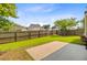Backyard featuring a concrete patio and a well-maintained lawn with a wood fence at 3706 Blackjack Rd, Ladson, SC 29456