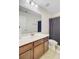 Bright bathroom featuring wood cabinets, white countertops, and a bathtub with a dark shower curtain at 3706 Blackjack Rd, Ladson, SC 29456