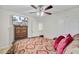 Comfortable bedroom with a ceiling fan, and a plush black leather bed with decorative pillows and bedding at 3706 Blackjack Rd, Ladson, SC 29456