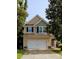 Charming two-story home with a two-car garage, neutral siding, and lush green trees, offering a welcoming curb appeal at 3706 Blackjack Rd, Ladson, SC 29456