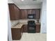 Efficient kitchen layout with dark cabinets, granite countertops, and modern appliances, offering a functional cooking space at 3706 Blackjack Rd, Ladson, SC 29456
