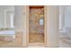 Well-appointed bathroom featuring tiled walk-in shower, natural stone surround, and neutral color palette at 400 Bay Crossing Rd, Mount Pleasant, SC 29464