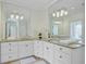 Bright bathroom features dual sinks, granite counters, custom cabinets, and decorative lighting at 400 Bay Crossing Rd, Mount Pleasant, SC 29464