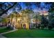 Charming three-story home at dusk, featuring manicured lawn and garden at 400 Bay Crossing Rd, Mount Pleasant, SC 29464