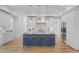 A bright kitchen features white cabinets, blue island, stainless steel appliances, and hardwood floors at 400 Bay Crossing Rd, Mount Pleasant, SC 29464