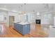 Open-concept kitchen featuring a large island, hardwood floors, and a modern fireplace at 400 Bay Crossing Rd, Mount Pleasant, SC 29464
