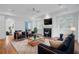 A formal living room features navy furniture, a fireplace, hardwood floors, and recessed lighting at 400 Bay Crossing Rd, Mount Pleasant, SC 29464
