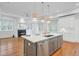 Open-concept living room with an island, fireplace, and hardwood floors at 400 Bay Crossing Rd, Mount Pleasant, SC 29464