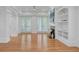 Spacious living room features a fireplace, built-in shelving, and French doors to an outdoor patio at 400 Bay Crossing Rd, Mount Pleasant, SC 29464