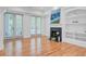 Spacious living room features a fireplace, built-in shelving, and French doors to an outdoor patio at 400 Bay Crossing Rd, Mount Pleasant, SC 29464