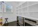 Walk-in pantry with white shelving, stainless steel appliances, and tile floors at 400 Bay Crossing Rd, Mount Pleasant, SC 29464