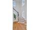 Bright staircase with hardwood treads, carpet runner, black railing, and decorative arched windows at 400 Bay Crossing Rd, Mount Pleasant, SC 29464
