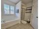 Bright bathroom with a soaking tub, separate shower, and white cabinets at 4013 Conant Rd, Mount Pleasant, SC 29466
