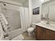 Bright bathroom with white shower curtain, framed boat art, vanity, and ceramic tile flooring at 4013 Conant Rd, Mount Pleasant, SC 29466