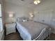 Bedroom with a white wrought-iron bed, ceiling fan and ample natural light from the window at 4013 Conant Rd, Mount Pleasant, SC 29466