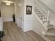 Welcoming entryway features wood-look floors, white wainscoting, and a staircase at 4013 Conant Rd, Mount Pleasant, SC 29466