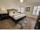 Comfortable primary bedroom with tray ceiling features a plush bed, bedside tables and neutral decor at 4013 Conant Rd, Mount Pleasant, SC 29466