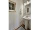 Modern powder room with pedestal sink, stylish mirror, and wood-look flooring at 4013 Conant Rd, Mount Pleasant, SC 29466