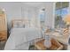 Cozy bedroom with white bedding, natural light, and unique wicker furniture at 403 Cool Bend Ln, Summerville, SC 29486
