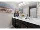 This bathroom features a large mirror, double vanity, and beach themed art and decor at 409 Grand Palm Ln, Summerville, SC 29485