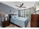 This primary bedroom features a ceiling fan and a view to the outside at 409 Grand Palm Ln, Summerville, SC 29485