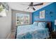 Inviting bedroom with a ceiling fan, comfortable bed, and accent wall for a relaxing retreat at 409 Grand Palm Ln, Summerville, SC 29485